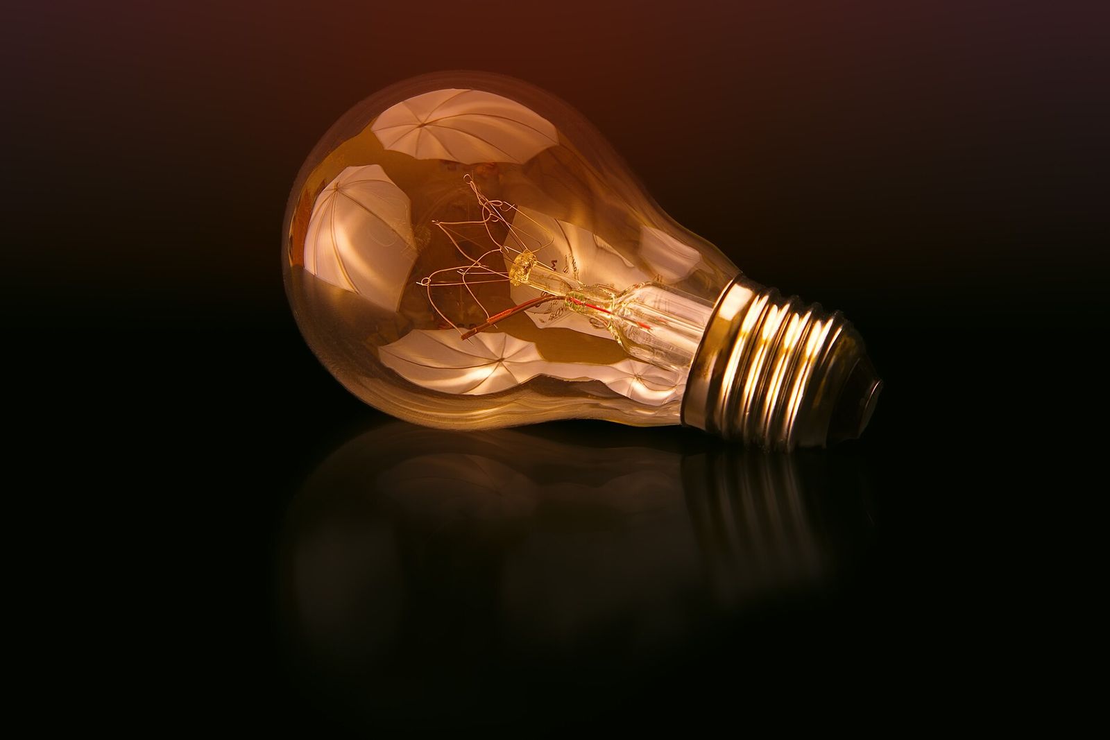An ST64 filament bulb against a dark background