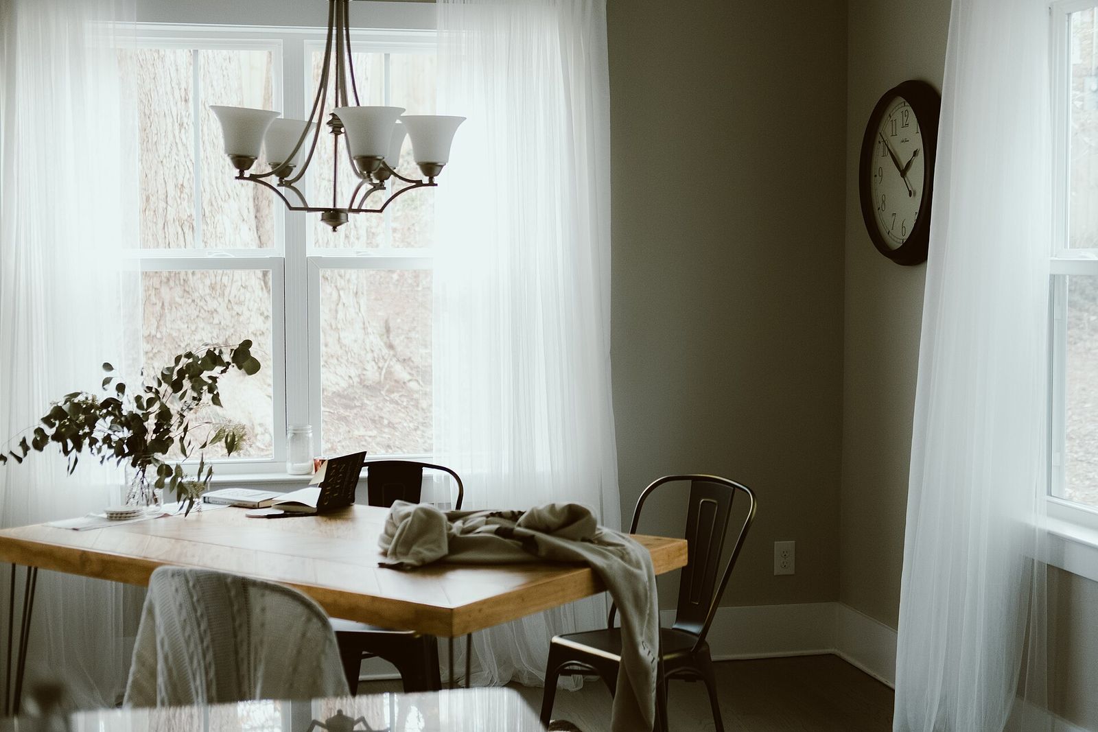 A chandelier over a dining table