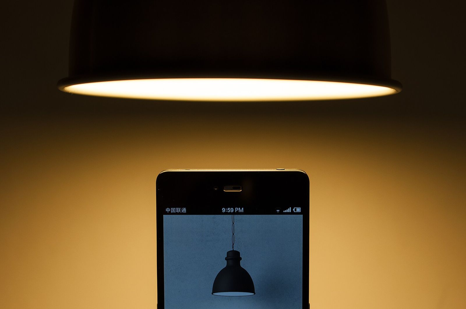 A drum pendant glowing over a table