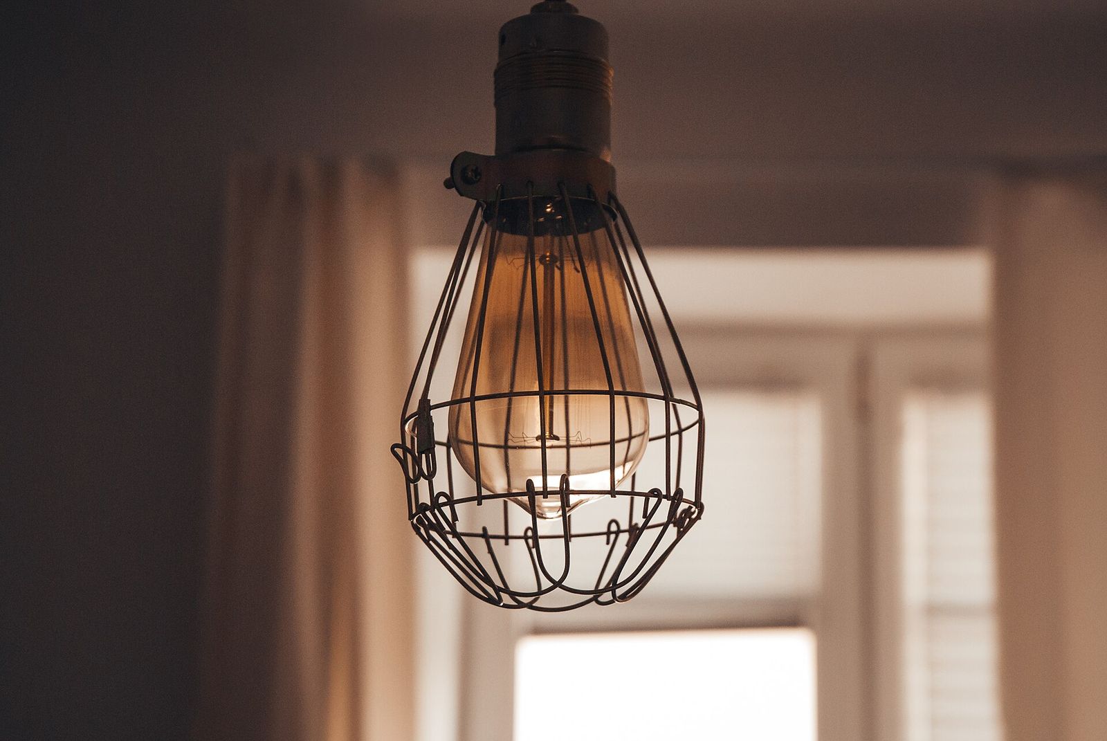 A cage lamp with a vintage bulb
