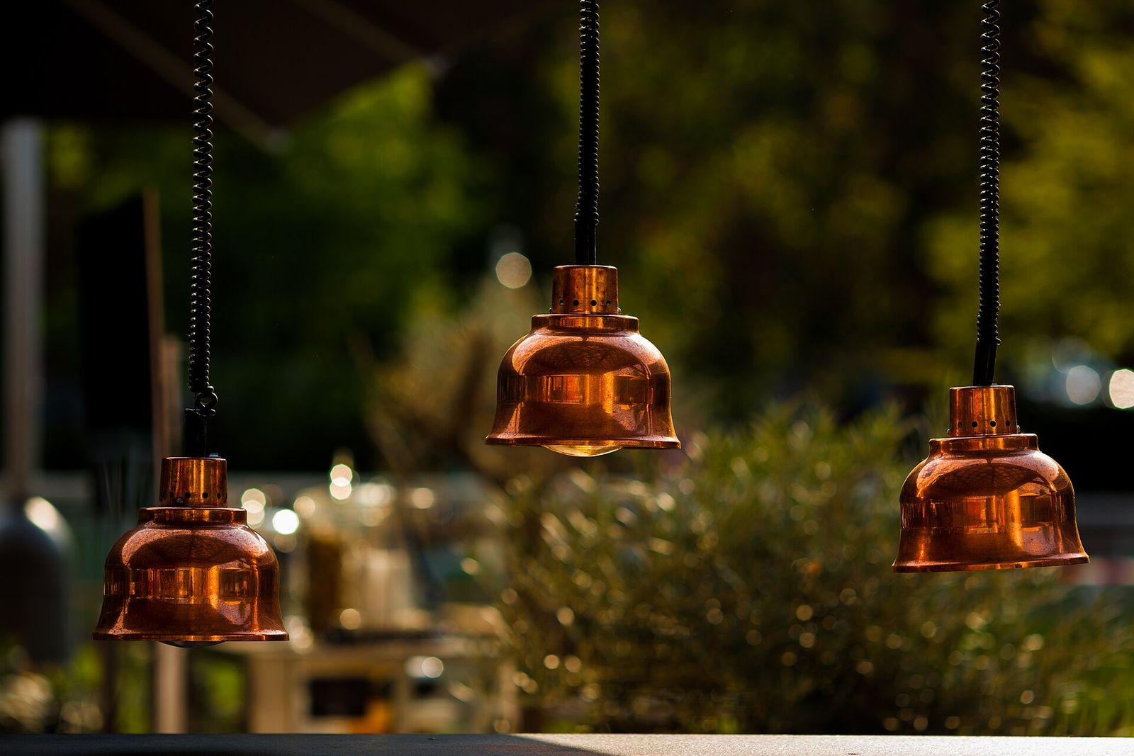 Copper dome pendants hanging in a row